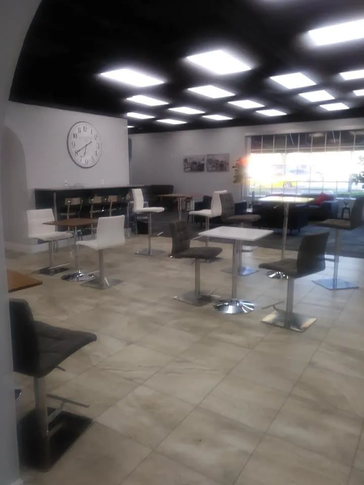 Commercial dining space with modern tables, adjustable seating, and contemporary lighting design