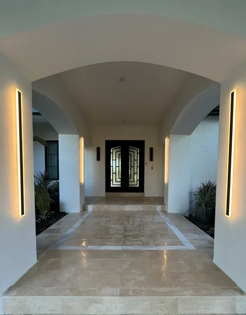 Stunning grand entrance foyer with marble flooring, dramatic LED ceiling lighting, and elegant archway design