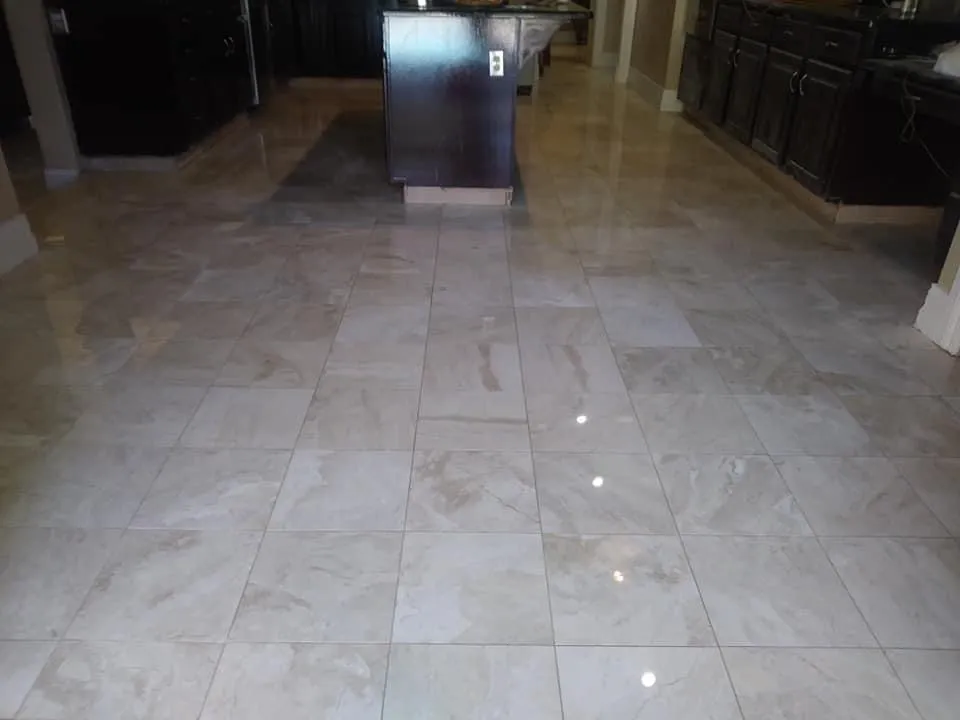 Kitchen renovation showing marble flooring installation around kitchen island area