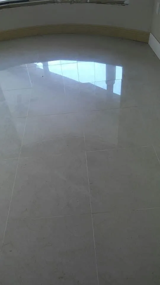 High-end bathroom flooring installation showing large format marble tiles with beautiful veining