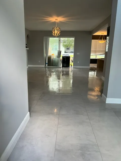 Contemporary entrance foyer with large format marble tiles and modern pendant lighting