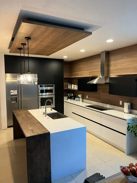 Contemporary kitchen with wood ceiling accent, large island, and modern appliances in sophisticated design