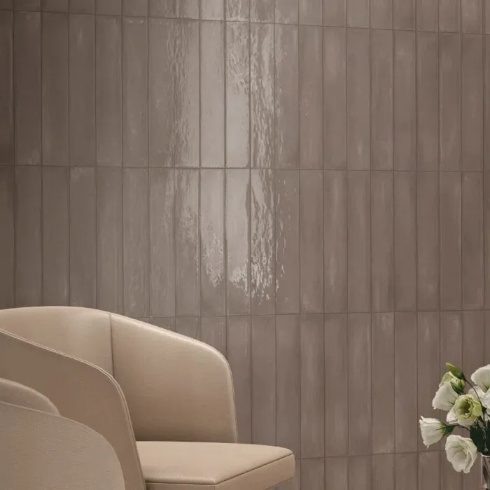 Contemporary living space featuring textured wall panels, modern curved chair, and sophisticated neutral color palette