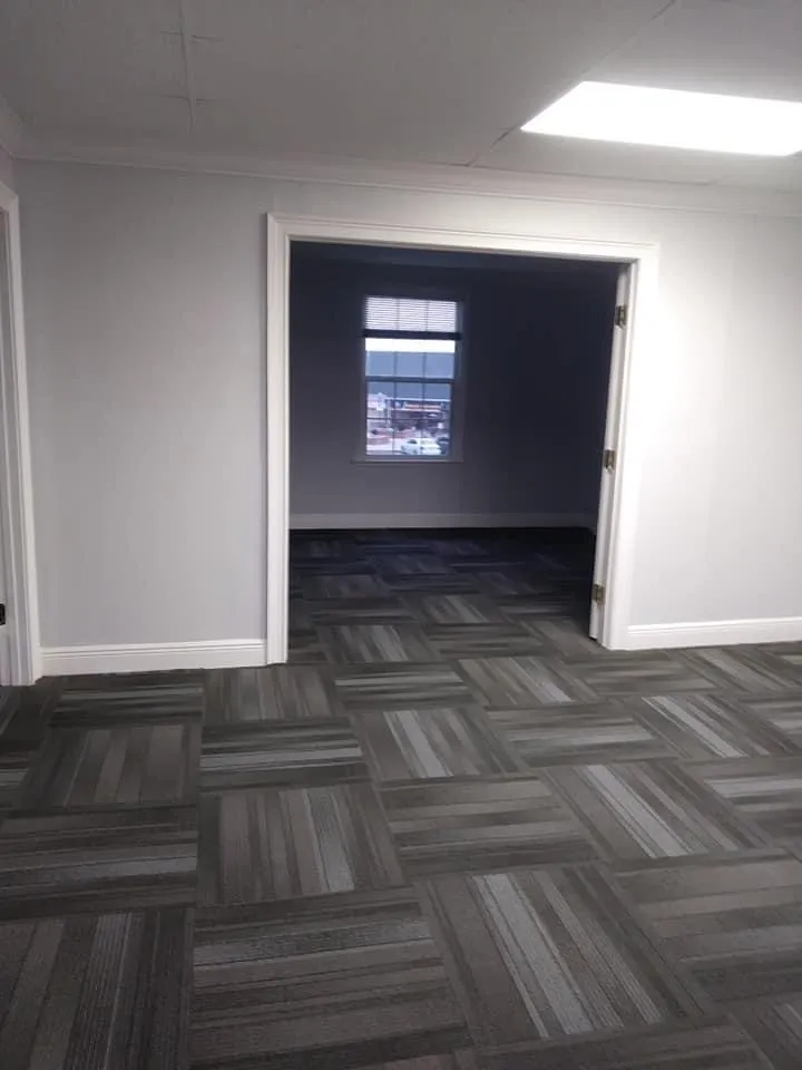 Commercial office space with modern carpet tile installation in geometric pattern